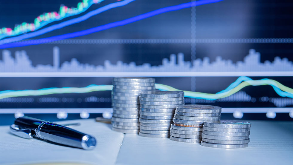 stack of coins with trading graph