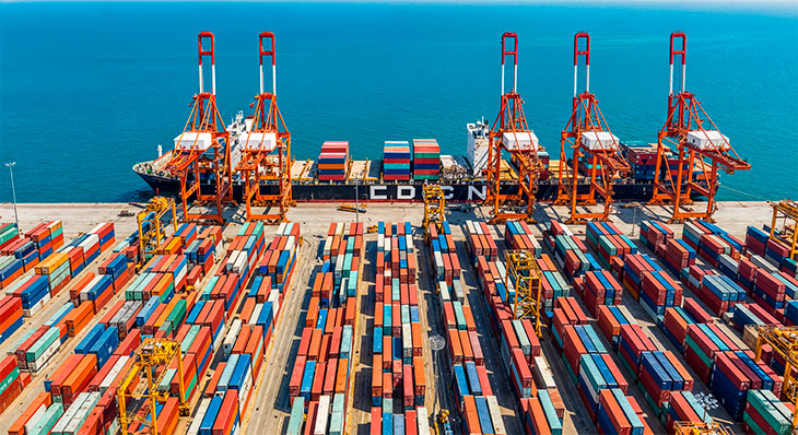 container port with cargo ship and cranes